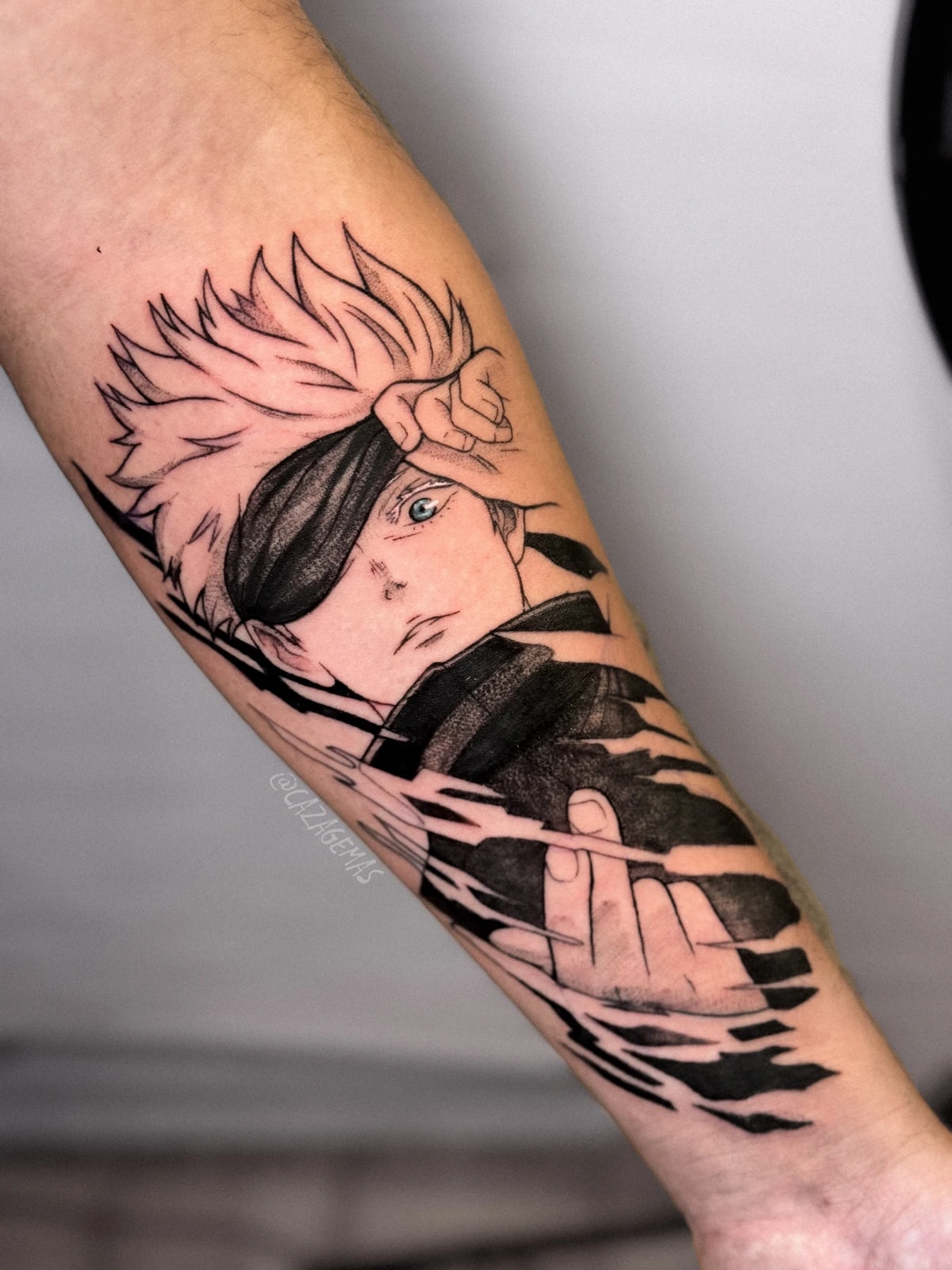 Tatuaje de un personaje de anime con parche en el ojo y efecto de trazos rotos