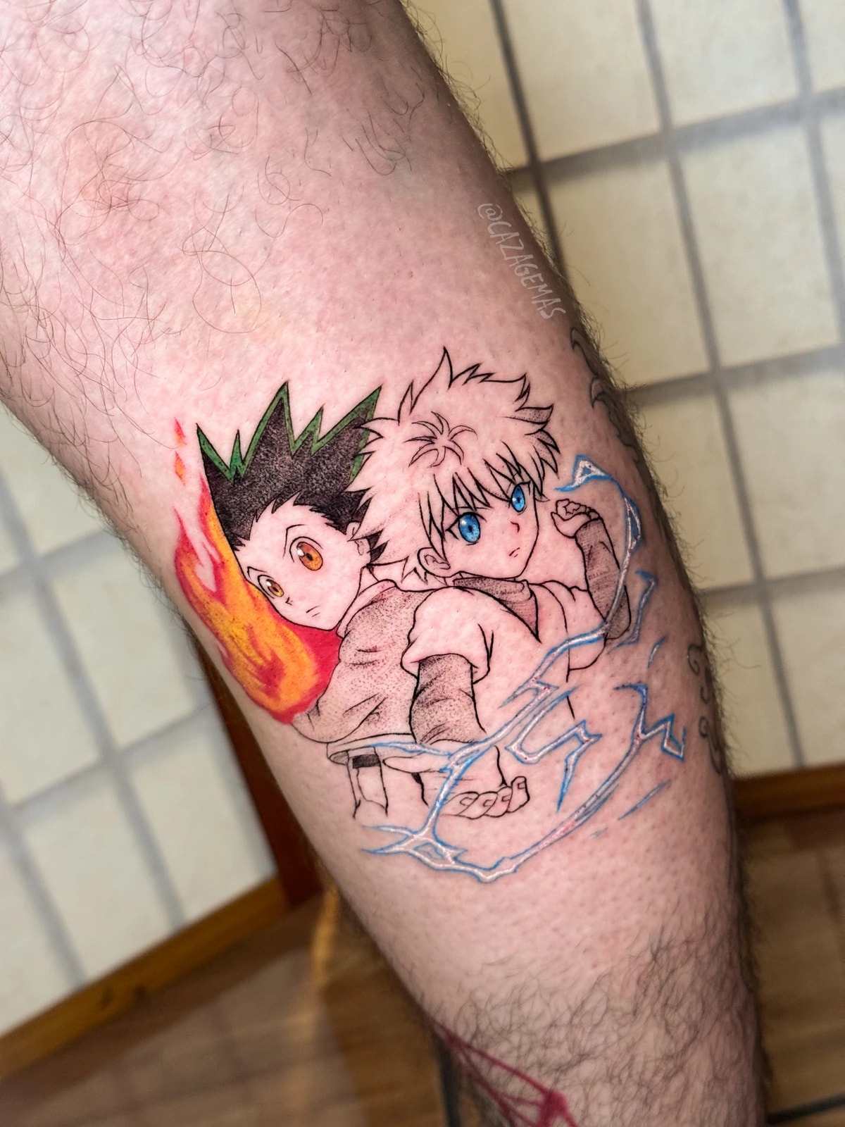 Tatuaje a color de Gon y Killua de Hunter x Hunter, con fuego y rayos, en línea fina